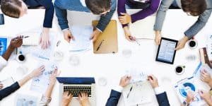 enterprise mobility for businesses, image shows businessmen gather around a white table