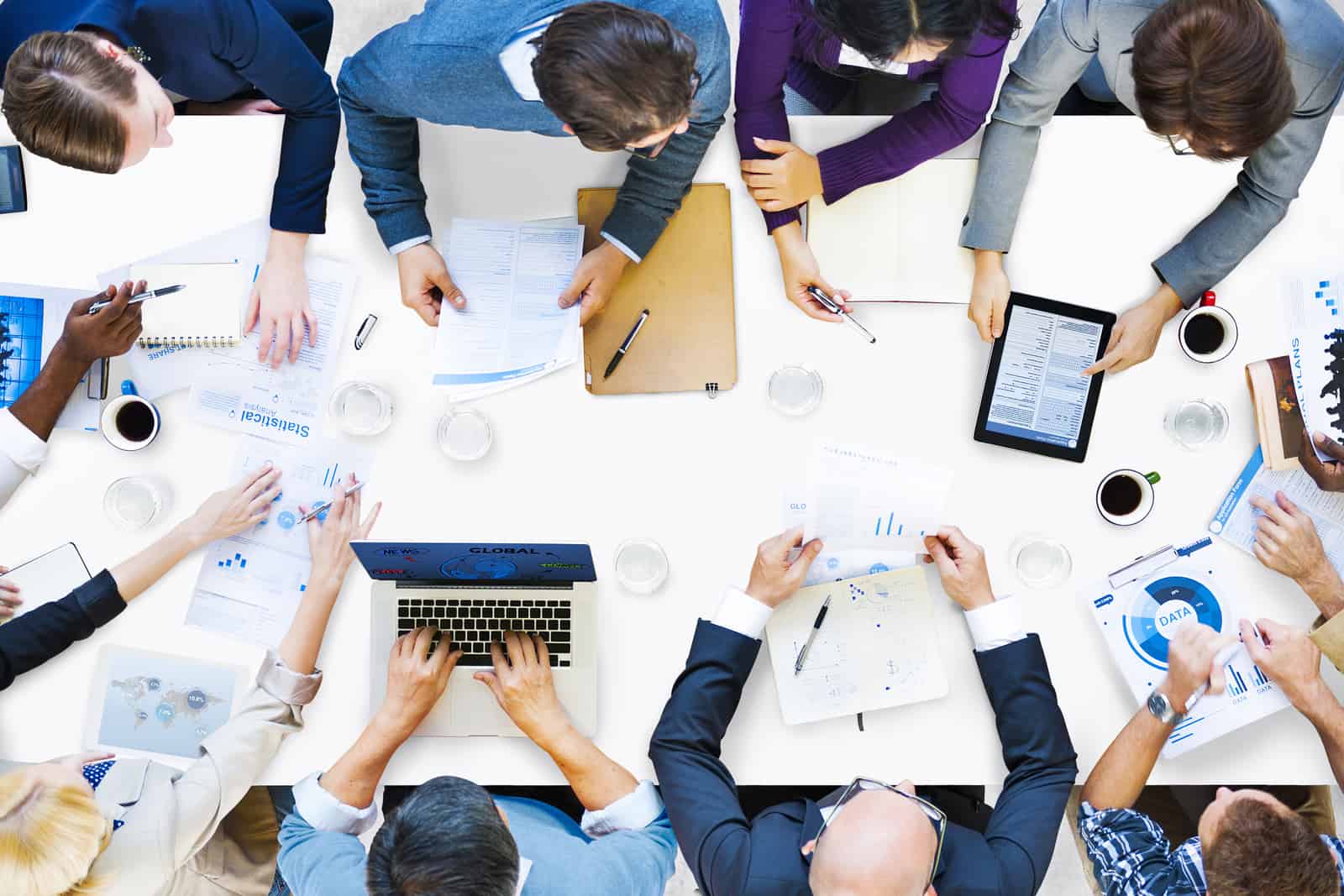enterprise mobility for businesses, image shows businessmen gather around a white table