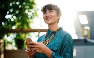 Mobile banking apps will change how we bank. Picture: Woman holding an smart phone.