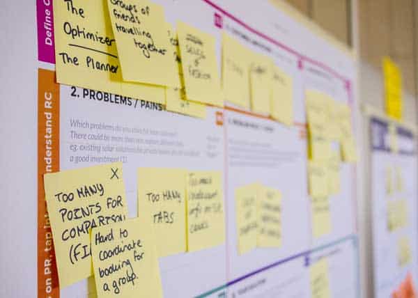 A board cluttered with post-its sharing mobile application development information