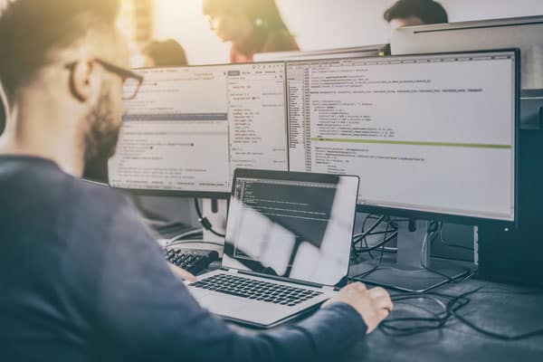 cloud development support and maintenance, developer writing code at desktop