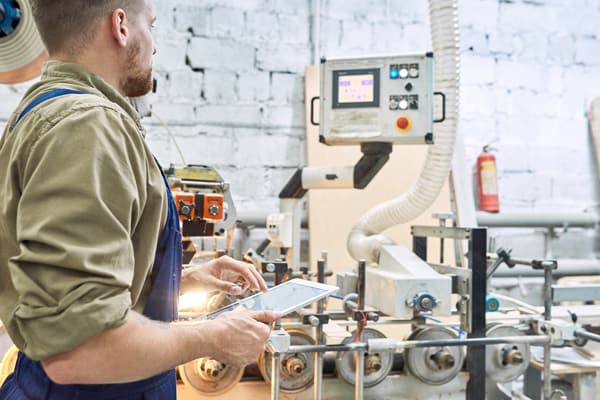 Worker watching over a digital machine